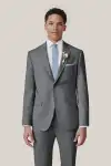 Man wearing tan Birdy Grey suit in slim fit, facing toward the camera.