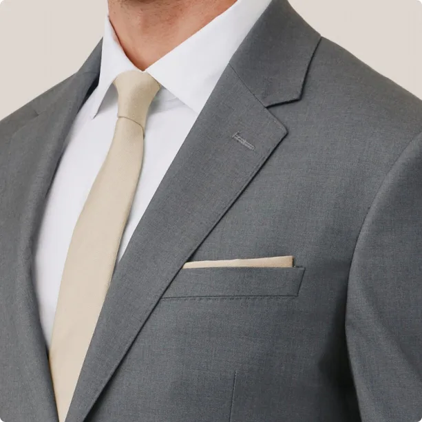 Suit jacket with visible pick stitching around the pocket and lapel.